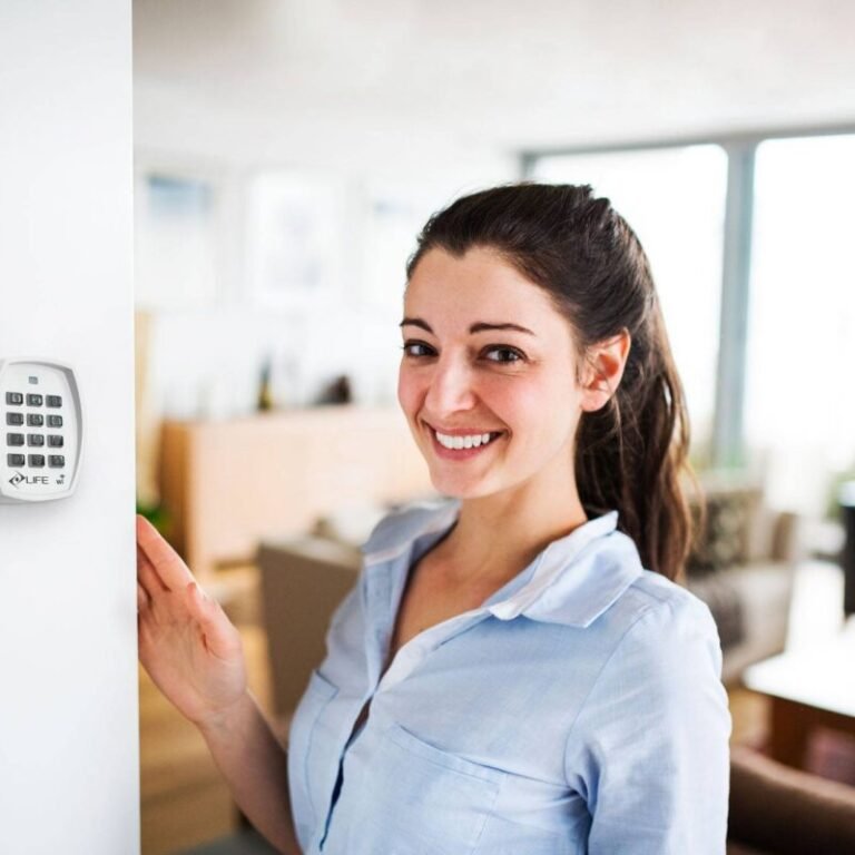 A woman looking at tablet with smart home control system.